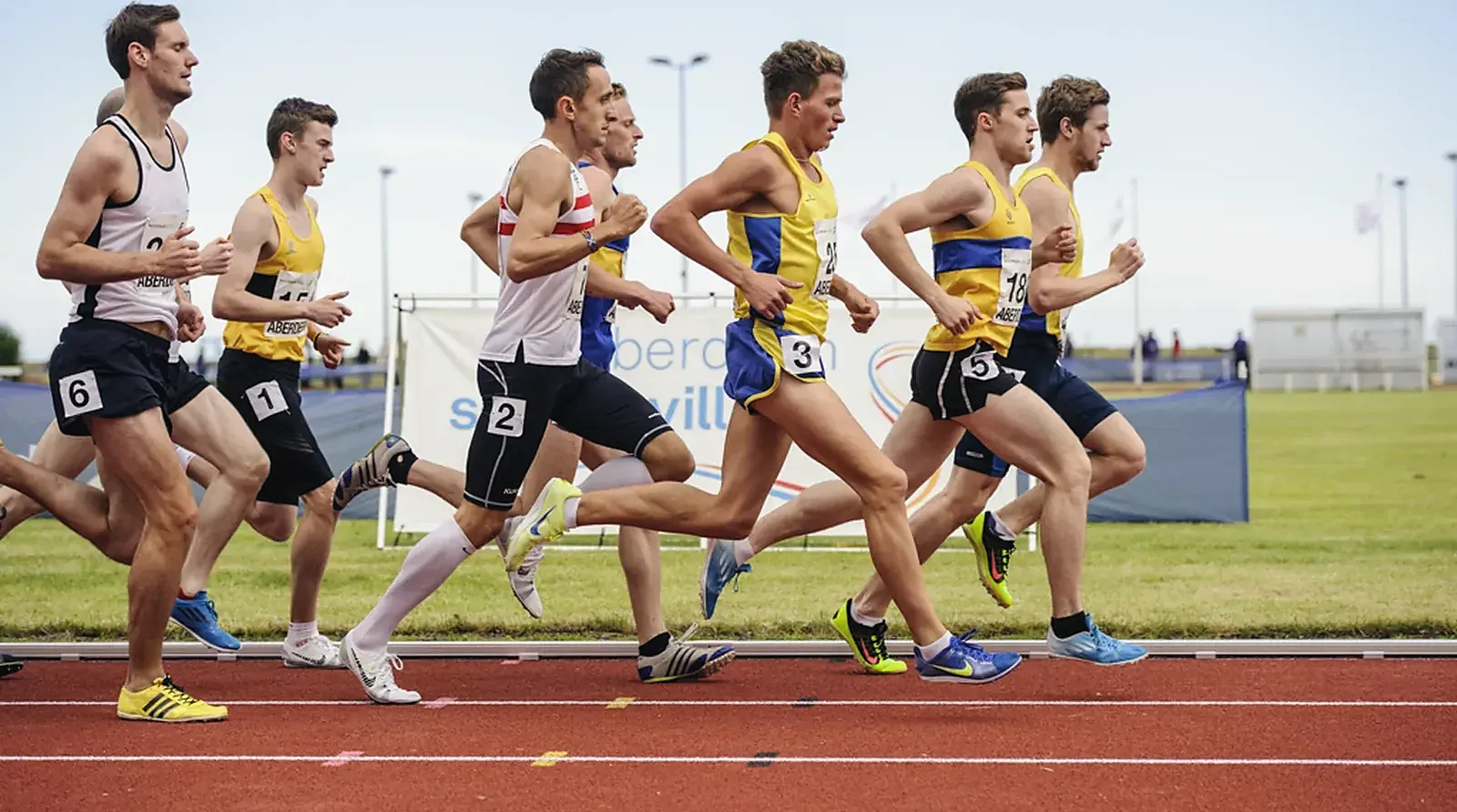 Runners racing on the track at Aberdeen Sports Village